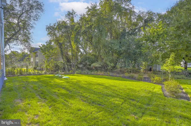 a view of yard with swimming pool and trees