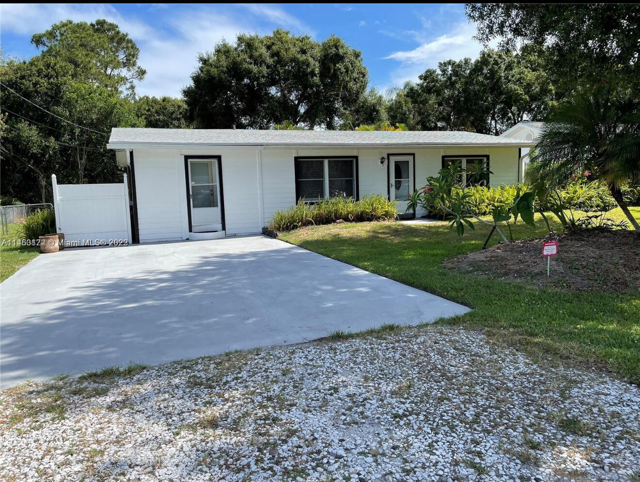 a front view of a house with a yard and trees