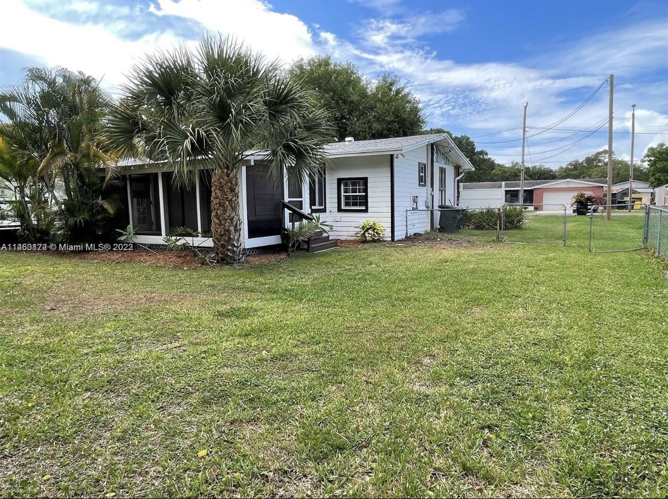 5000 Garner Street, Unit A Fort Pierce, FL 34981 - Photo 2 of 10 a front view of a house with a garden and trees