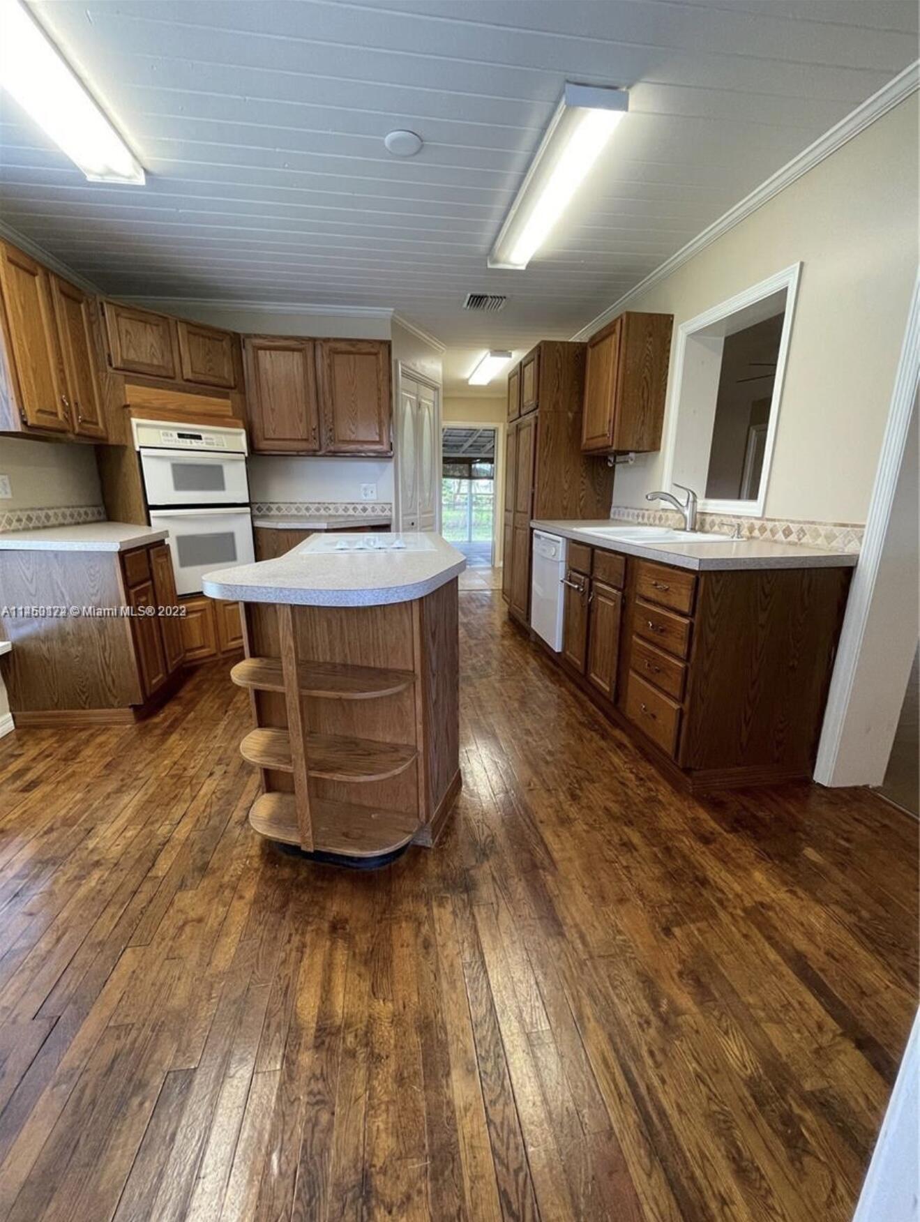 5000 Garner Street, Unit A Fort Pierce, FL 34981 - Photo 5 of 10 a living room with furniture and a wooden floor