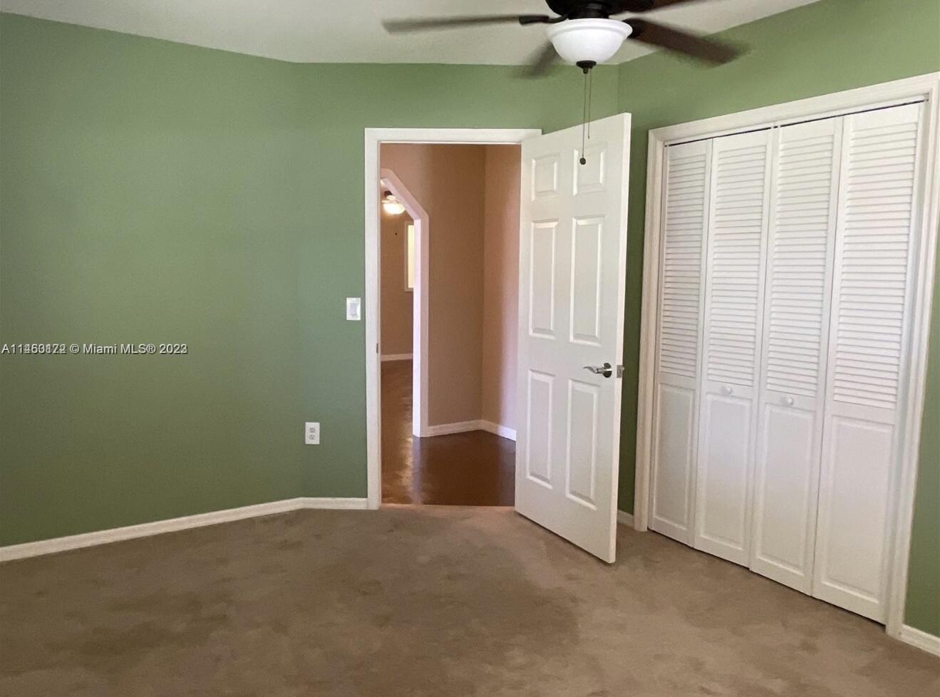 5000 Garner Street, Unit A Fort Pierce, FL 34981 - Photo 7 of 10 an empty room with a ceiling fan and closet area