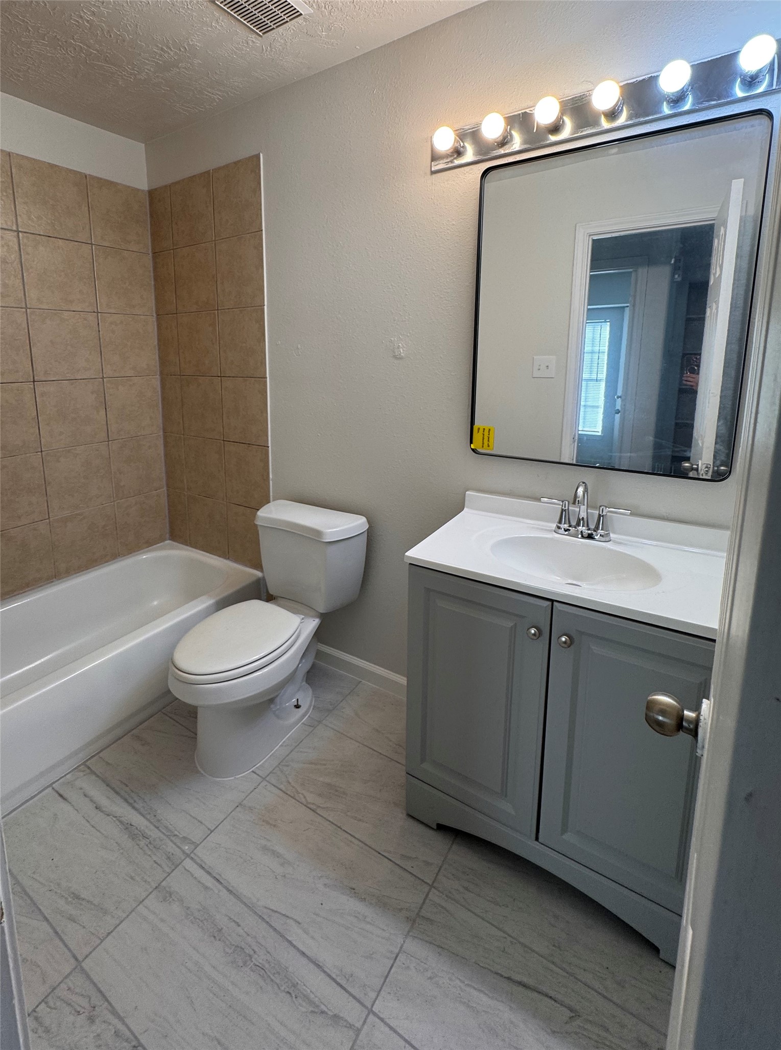 15931 Winston Point Lane Houston, TX 77084 - Photo 9 of 15 a spacious bathroom with a sink a toilet a mirror and shower