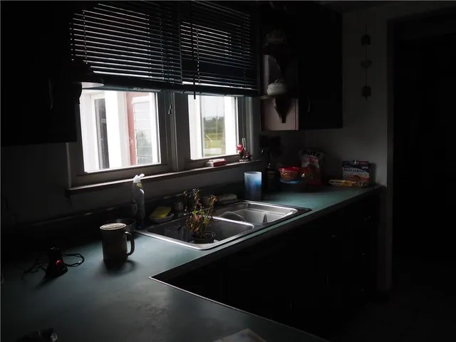 a kitchen with a sink and cabinets