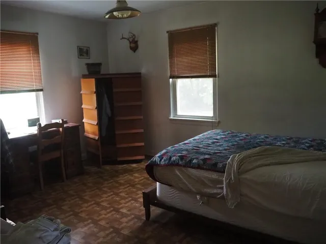 a bedroom with a bed and a dresser