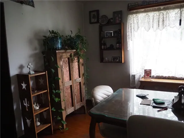 a dining room with furniture and wooden floor