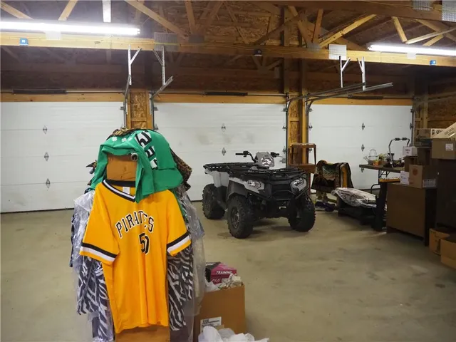 a kitchen with a stove and a wooden floor