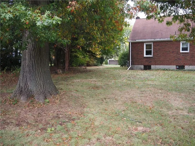 a view of a tree in front of a house