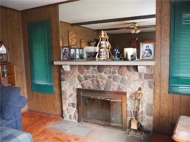 a room with fireplace and a wooden floor