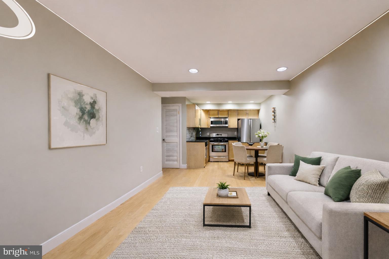 a living room with furniture and kitchen view