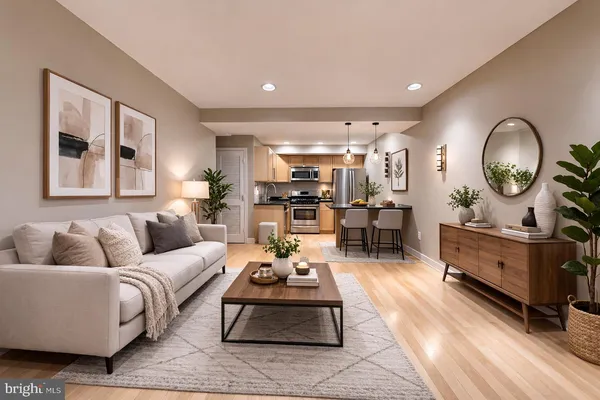 a living room with furniture and a wooden floor