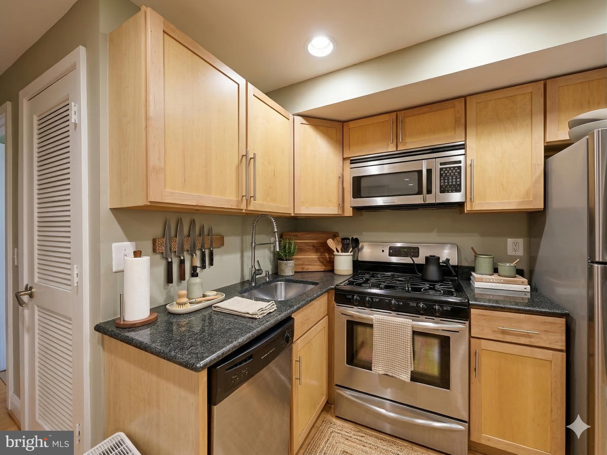 6 Rhode Island Avenue Northwest, Unit 2 Washington, DC 20001 - Photo 3 of 29 a kitchen with stainless steel appliances granite countertop a stove a sink and a microwave