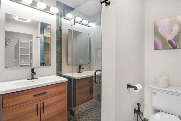 a bathroom with a double vanity sink mirror and toilet
