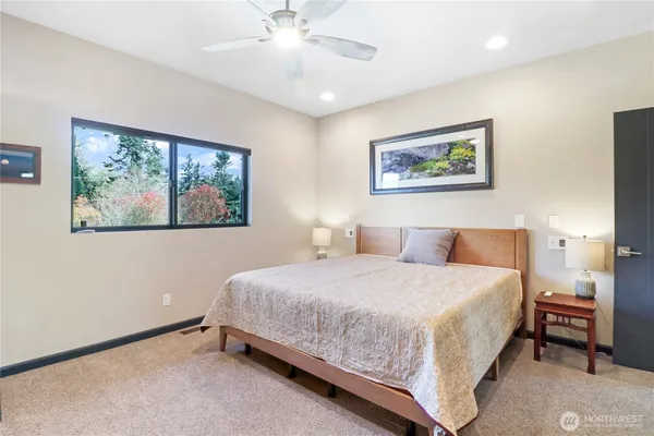a bedroom with a bed and a painting on the wall