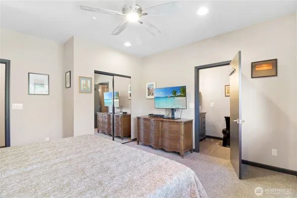 a bedroom with bed and cabinets