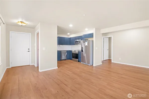 a view of a kitchen with a sink and a refrigerator