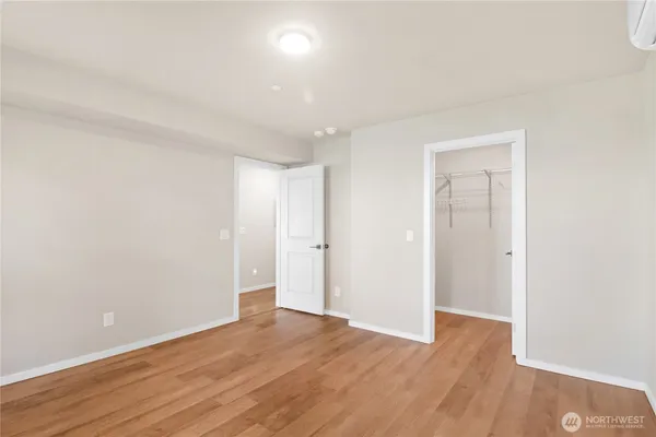 a view of an empty room with wooden floor