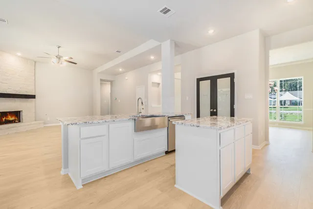 a kitchen with stainless steel appliances granite countertop a stove and a refrigerator