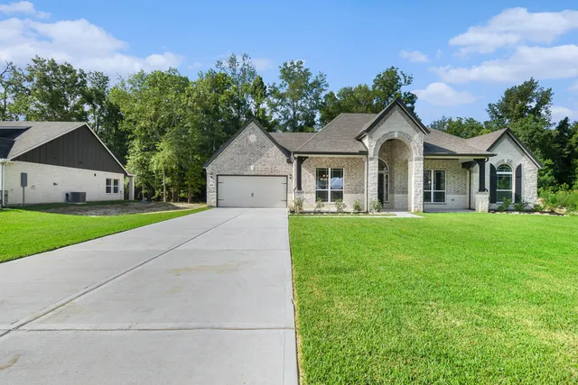 a front view of house with yard and green space