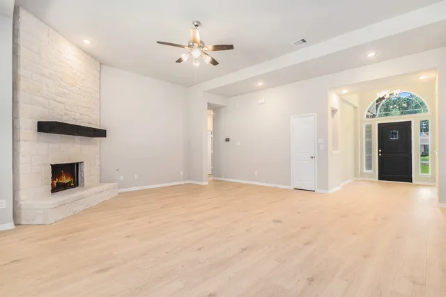a view of an empty room with a fireplace