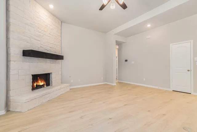 a view of an empty room with a fireplace