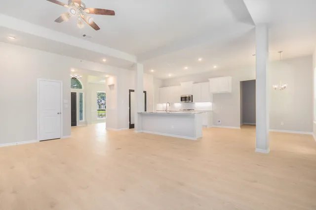a view of a kitchen with a sink and a refrigerator