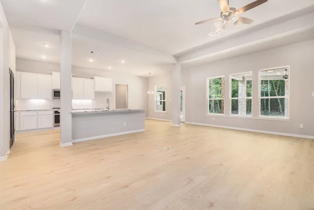 a view of an empty room with a kitchen
