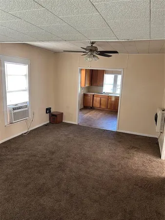 a view of a livingroom with a ceiling fan and window