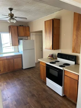 a kitchen with a stove and a refrigerator