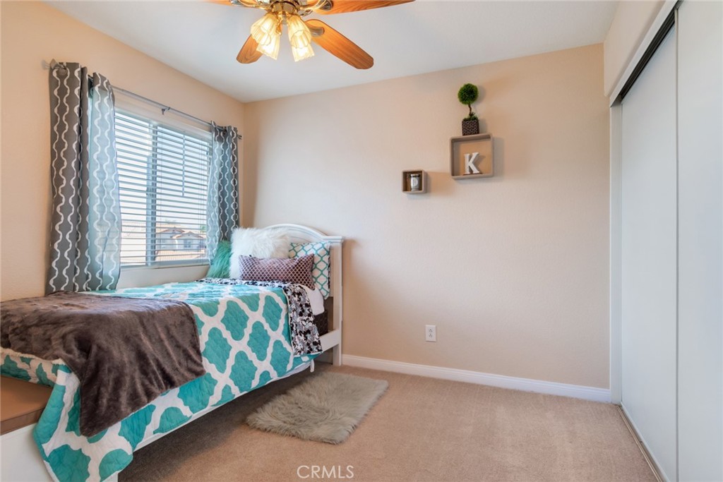 20885 Bakal Drive Riverside, CA 92508 - Photo 27 of 47 a bedroom with a bed and a chandelier