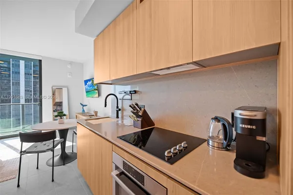 a view of a kitchen with a sink and furniture
