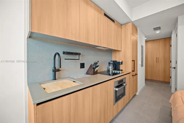 a kitchen that has a sink and a stove in it