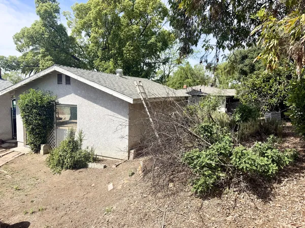 a kitchen with stainless steel appliances granite countertop a refrigerator a stove a sink and a microwave