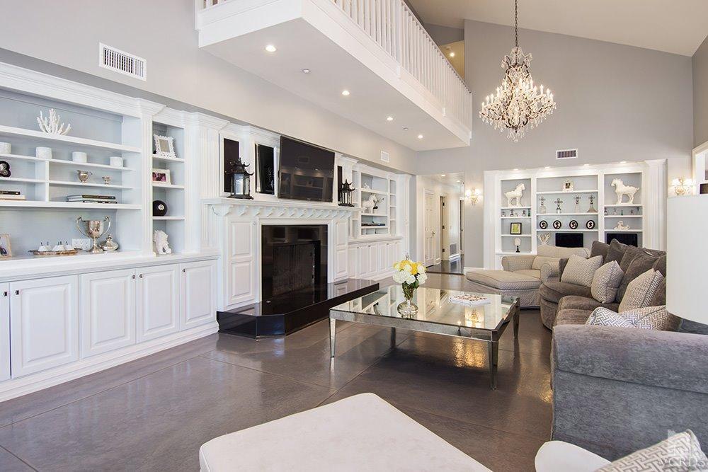 1784 Upper Ranch Road Westlake Village, CA 91362 - Photo 22 of 53 a living room with furniture a fireplace and a chandelier
