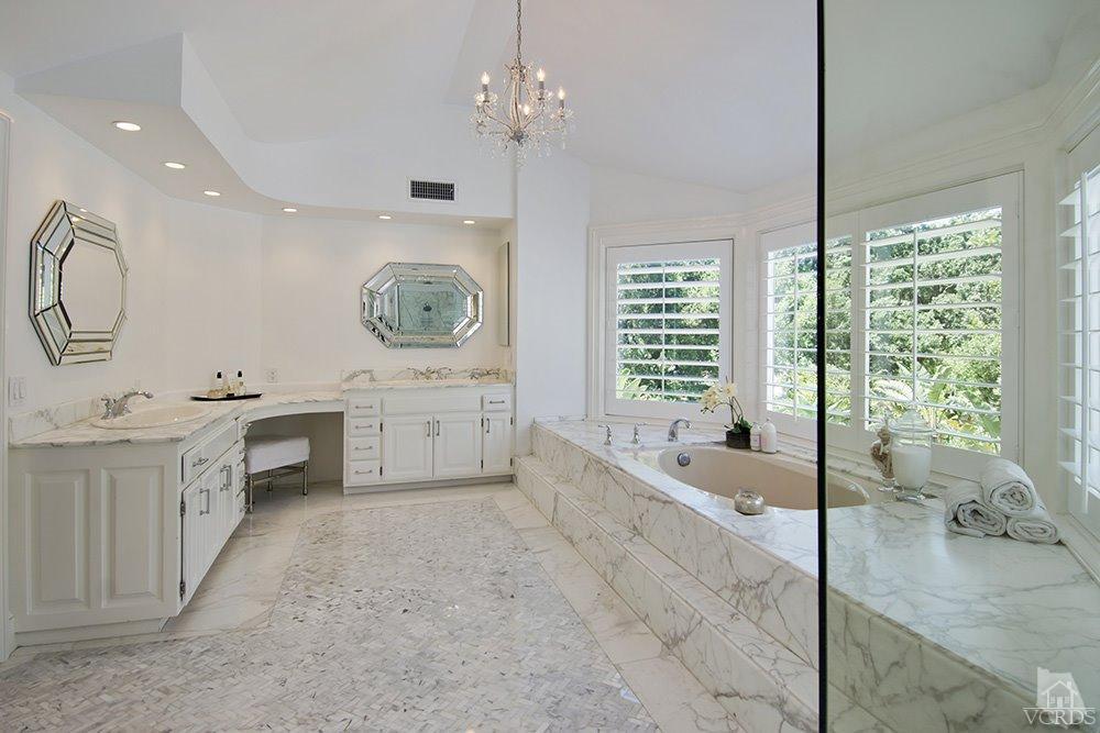 1784 Upper Ranch Road Westlake Village, CA 91362 - Photo 29 of 53 a spacious bathroom with a double vanity sink a large mirror and a bathtub