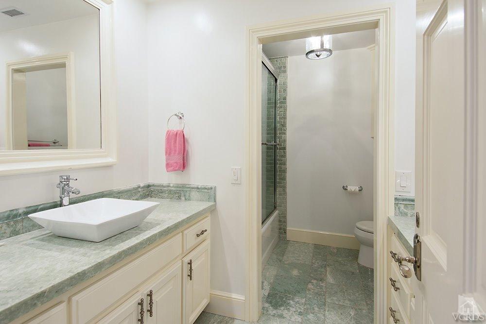 1784 Upper Ranch Road Westlake Village, CA 91362 - Photo 32 of 53 a bathroom with a granite countertop sink a mirror and a shower