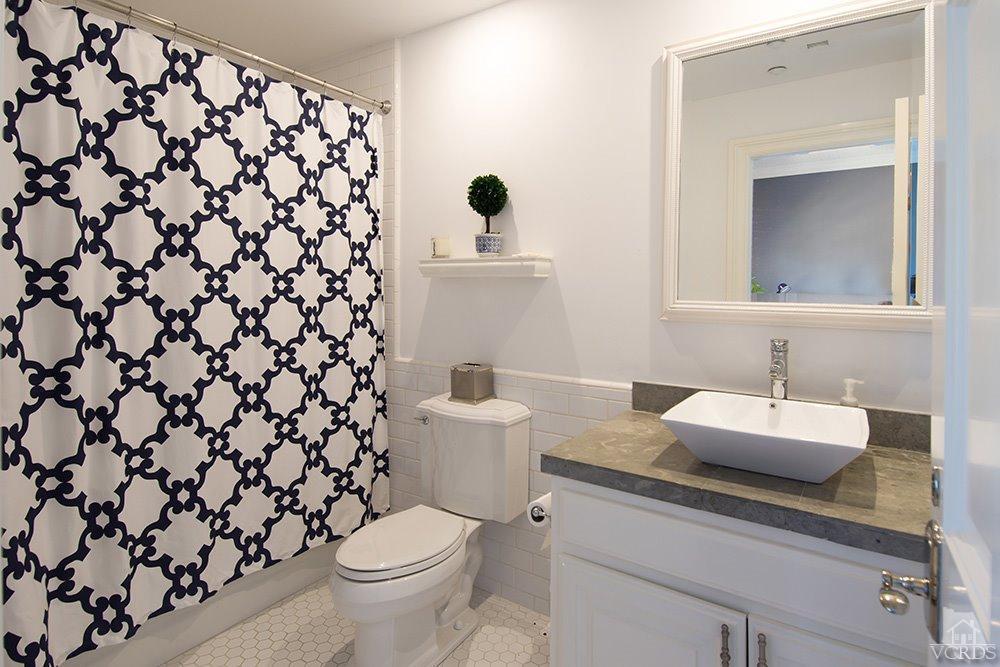 1784 Upper Ranch Road Westlake Village, CA 91362 - Photo 36 of 53 a bathroom with a granite countertop sink a toilet and a mirror