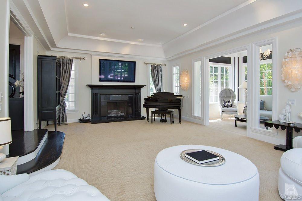1784 Upper Ranch Road Westlake Village, CA 91362 - Photo 10 of 53 a living room with furniture a fireplace and a flat screen tv