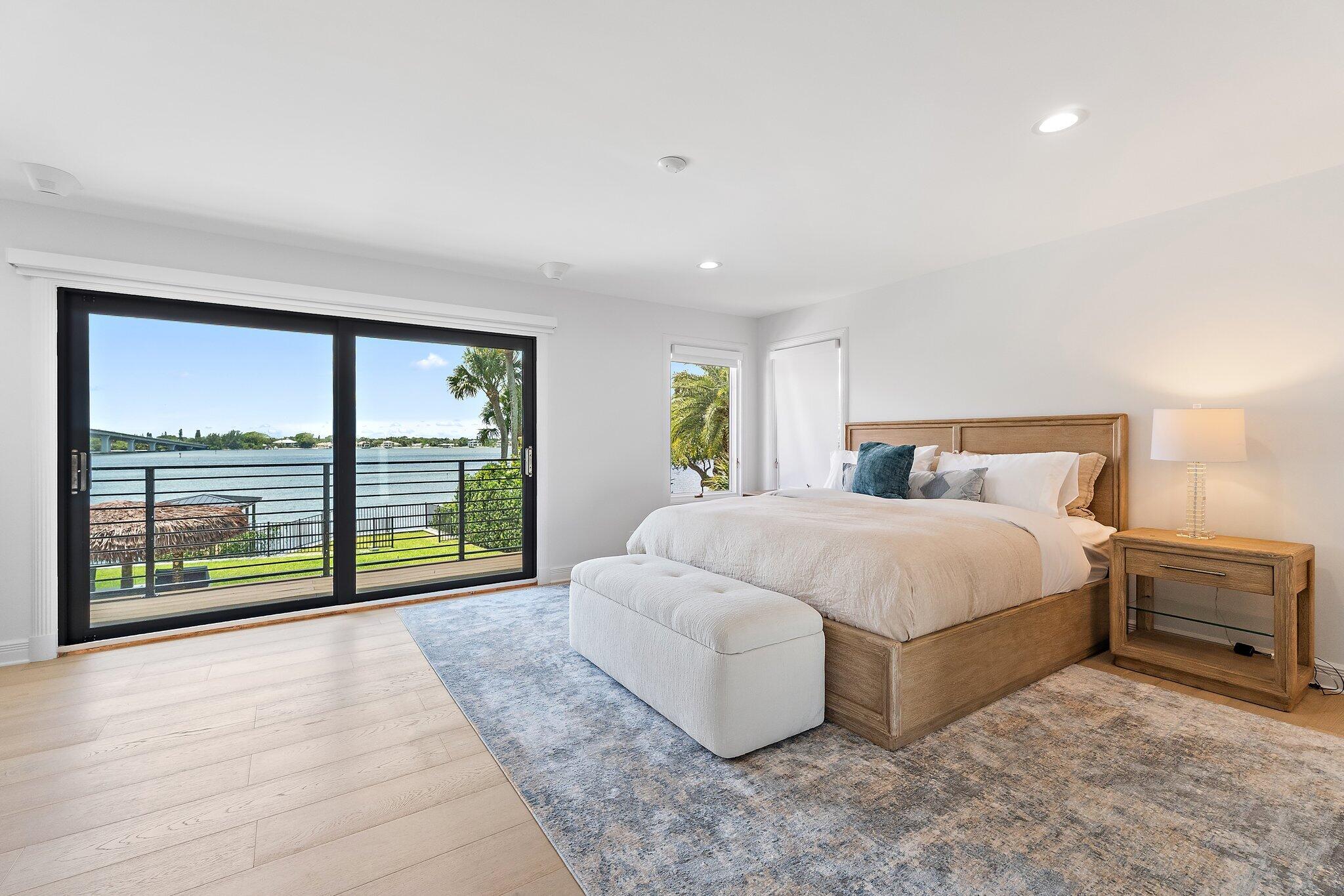 9 North River Road Stuart, FL 34996 - Photo 20 of 24 a spacious bedroom with a large bed and a large window