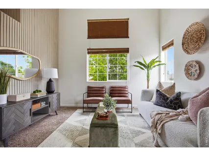 a living room with furniture a rug and a large window