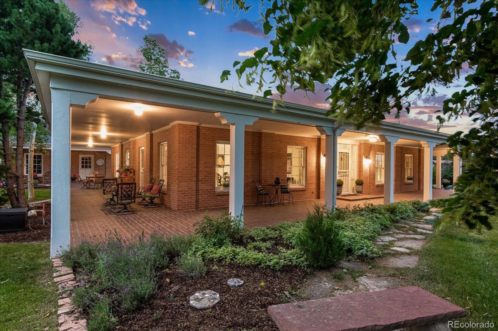 5225 Ridge Trail Bow Mar, CO 80123 - Photo 1 of 40 a view of a patio with table and chairs potted plants and floor to ceiling window