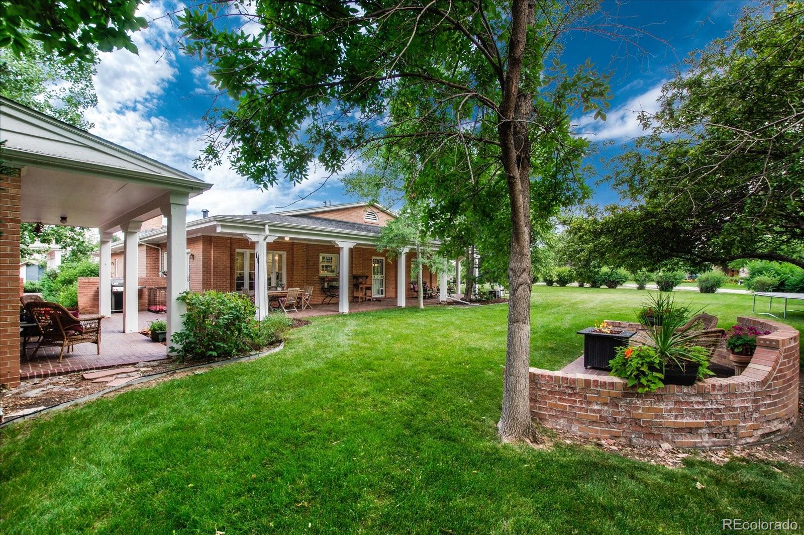 5225 Ridge Trail Bow Mar, CO 80123 - Photo 11 of 40 a front view of a house with a yard