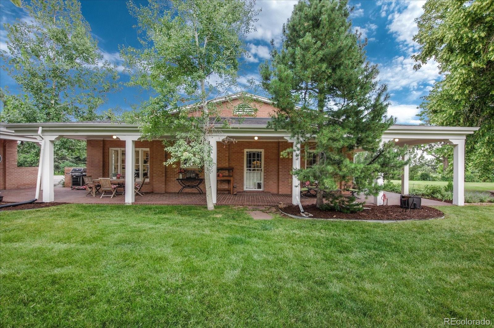 5225 Ridge Trail Bow Mar, CO 80123 - Photo 13 of 40 a front view of house with yard and outdoor seating