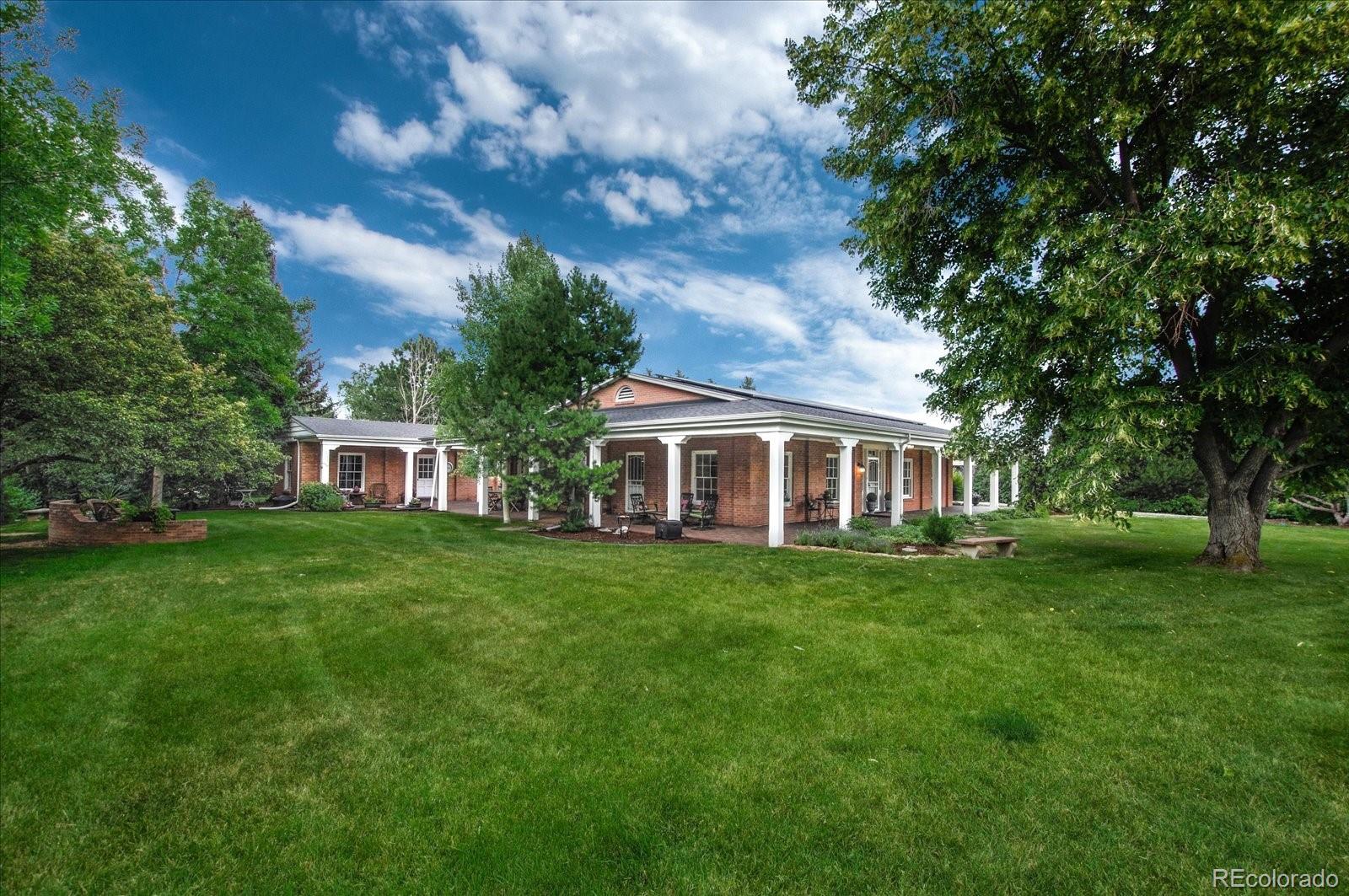 5225 Ridge Trail Bow Mar, CO 80123 - Photo 14 of 40 a front view of a house with a garden