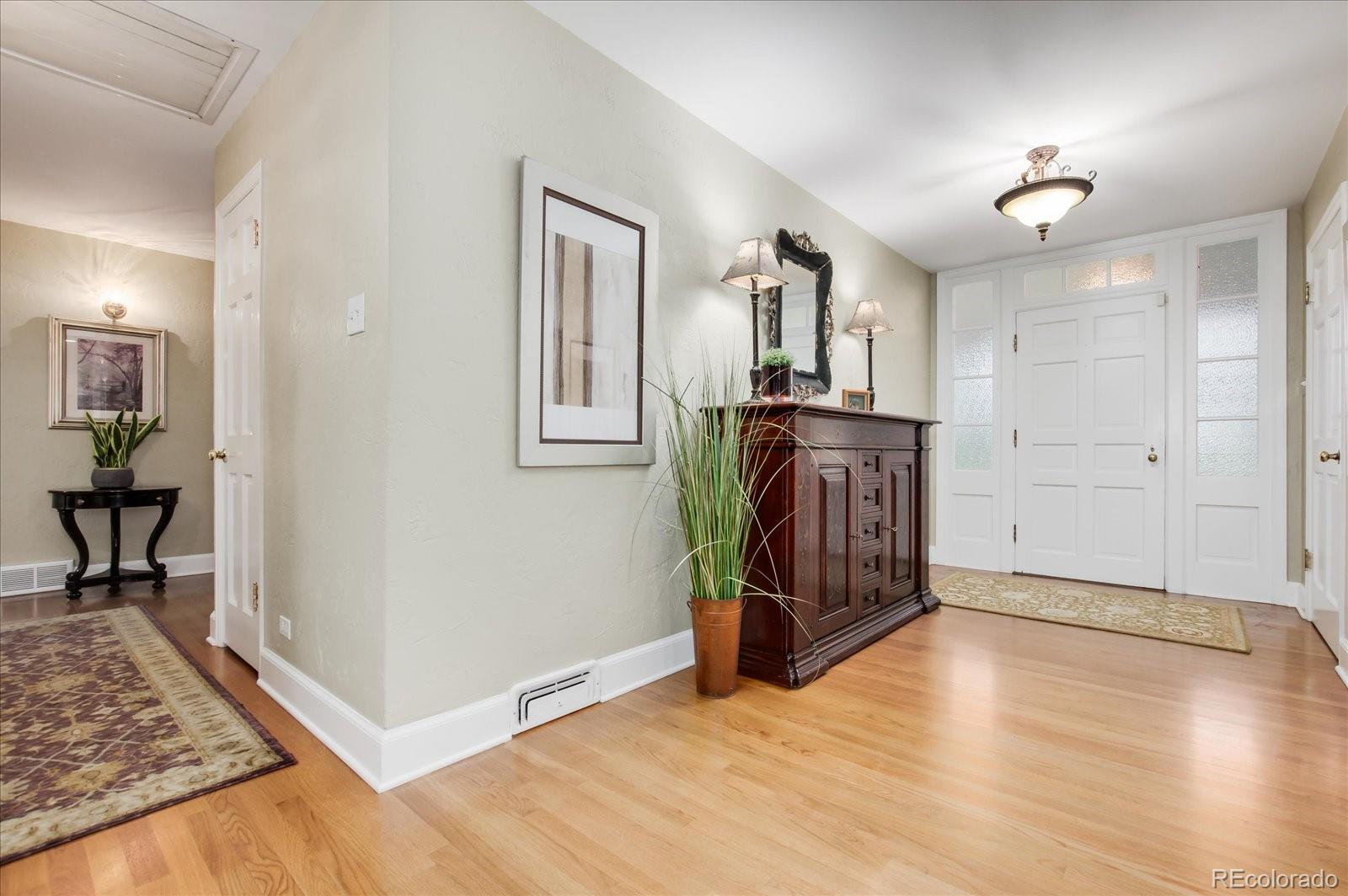 5225 Ridge Trail Bow Mar, CO 80123 - Photo 15 of 40 a view of a livingroom with wooden floor and a ceiling fan