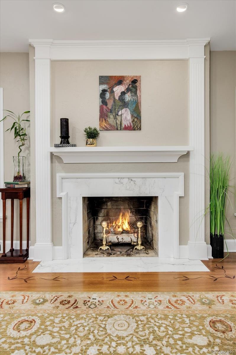 5225 Ridge Trail Bow Mar, CO 80123 - Photo 19 of 40 a living room with a fireplace and a potted plant