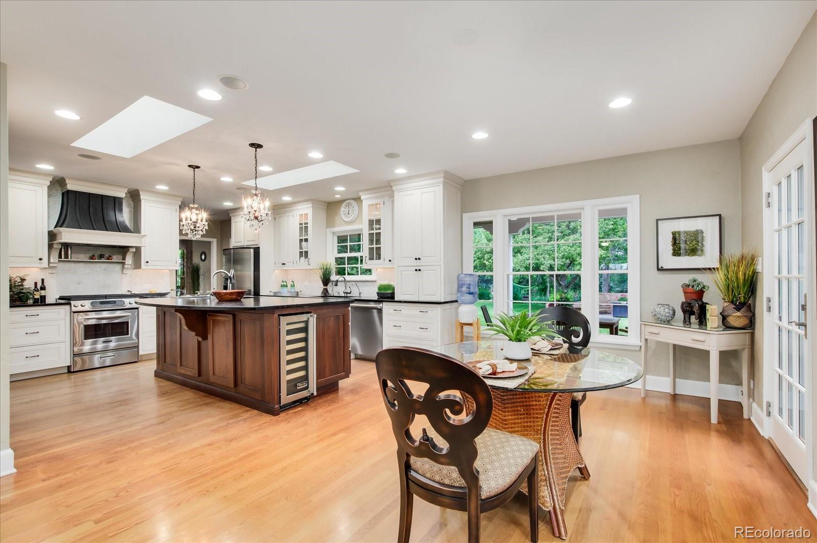 5225 Ridge Trail Bow Mar, CO 80123 - Photo 23 of 40 a view of a dining room with furniture window and wooden floor