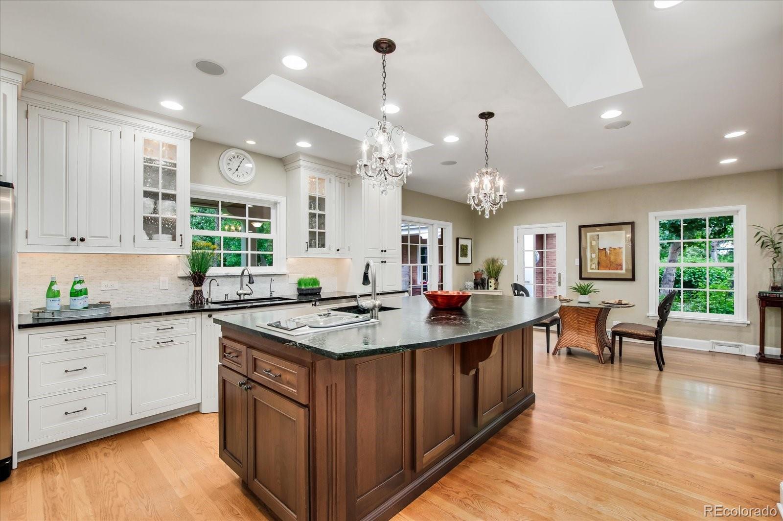 5225 Ridge Trail Bow Mar, CO 80123 - Photo 24 of 40 a kitchen with stainless steel appliances granite countertop a sink stove and wooden floor