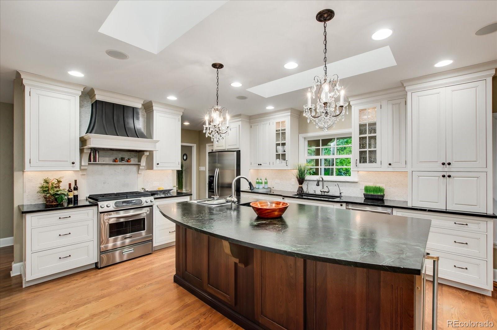 5225 Ridge Trail Bow Mar, CO 80123 - Photo 26 of 40 a kitchen with stainless steel appliances granite countertop a sink stove and refrigerator