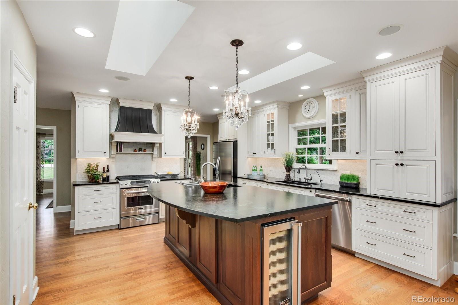5225 Ridge Trail Bow Mar, CO 80123 - Photo 27 of 40 a kitchen with stainless steel appliances granite countertop a sink stove and refrigerator