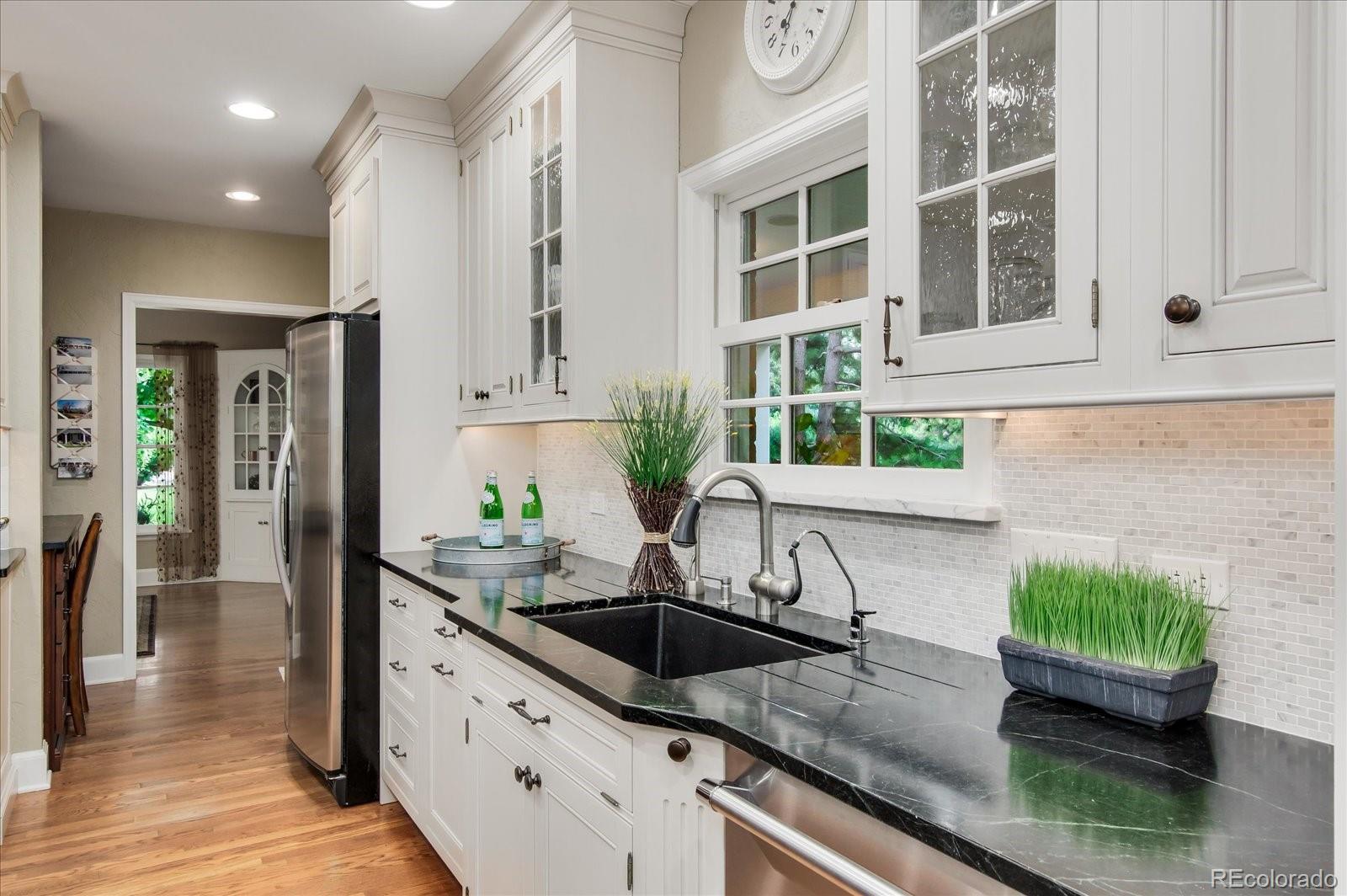 5225 Ridge Trail Bow Mar, CO 80123 - Photo 28 of 40 a kitchen with a sink and a white refrigerator